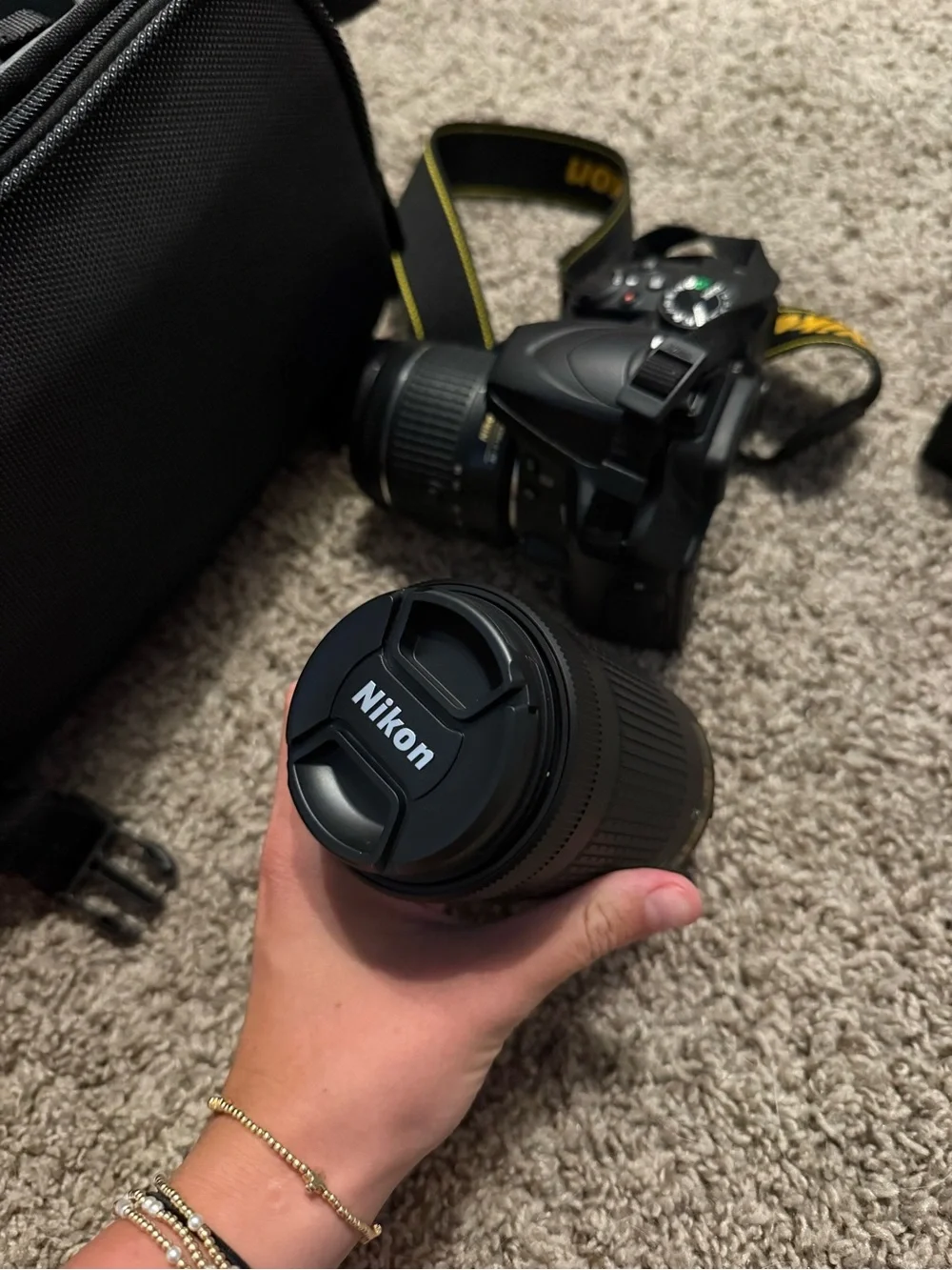 Nikon Black DSLR with Zoom Lens and Branded Neck Strap